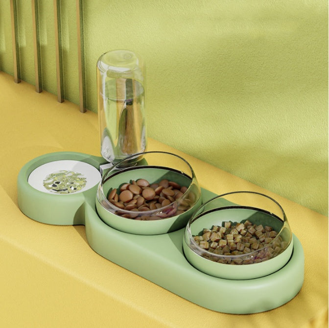 Green pet feeder with two bowls on a yellow surface