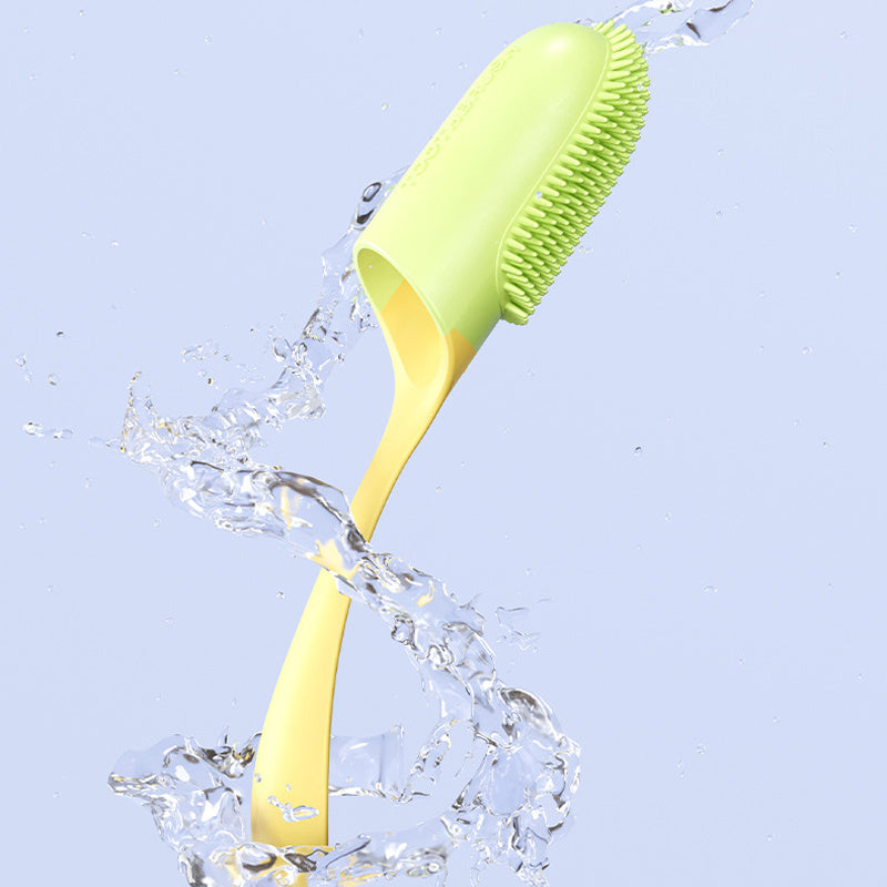 Green and yellow cleaning brush with water splashes on a light blue background