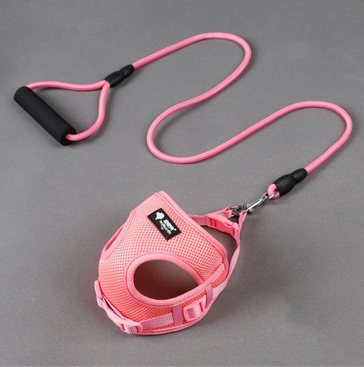 Pink dog harness and leash set on a gray background