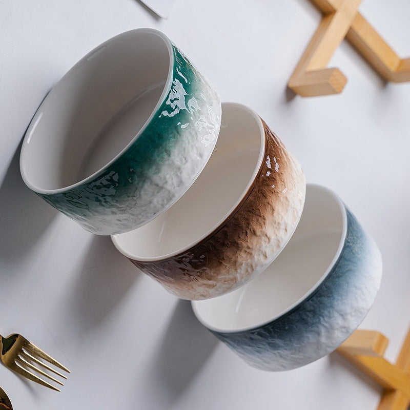 Three ceramic bowls with gradient patterns on a white surface.