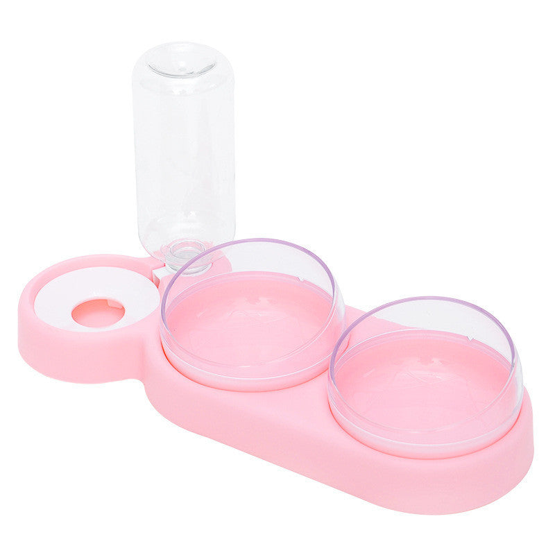 Pink pet feeder with three transparent bowls on a white background
