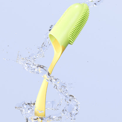 Green and yellow cleaning brush with water splashes on a light blue background