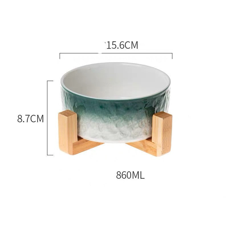 Green ceramic bowl with wooden stand and measurements on a white background