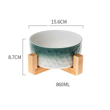 Green ceramic bowl with wooden stand and measurements on a white background