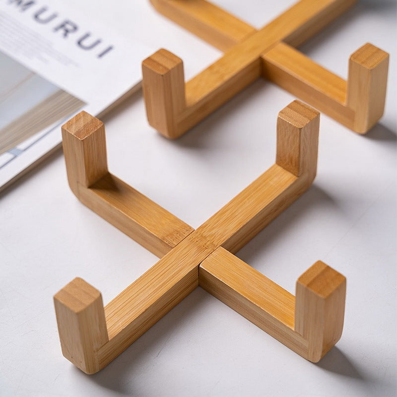 Wooden cross-shaped holder on a light background