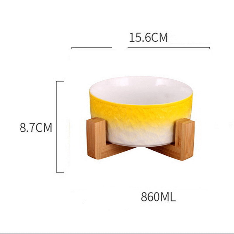 Yellow and white ceramic bowl with wooden stand and measurements on a white background